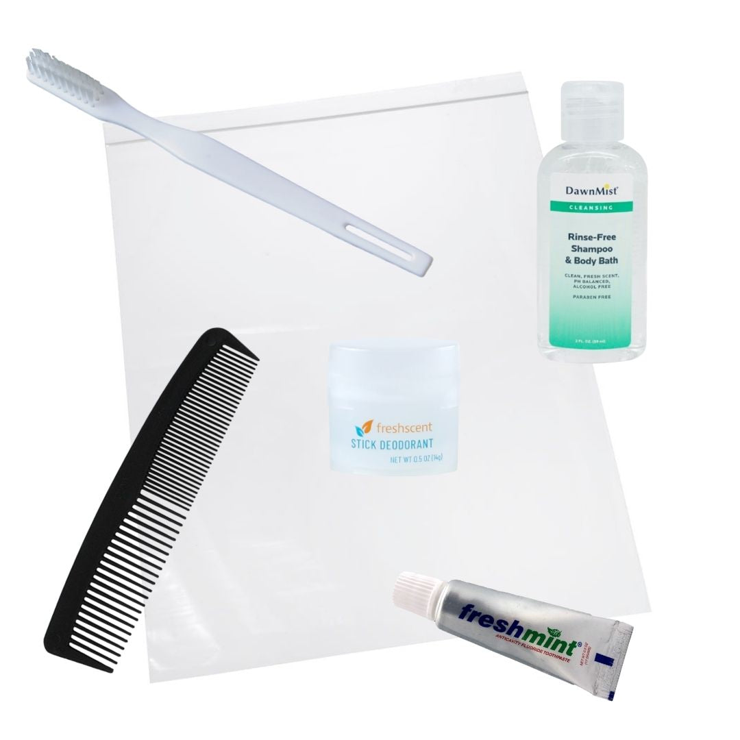 A hygiene kit containing a comb, toothbrush, toothpaste, deodorant stick, rinse free shampoo body wash, and a clear plastic bag.